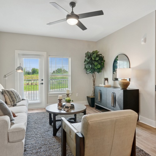 Cedar Model - Living Room  A living room with a couch, chair, and a table in the middle.