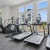  A gym with treadmills, exercise bikes, and other equipment.